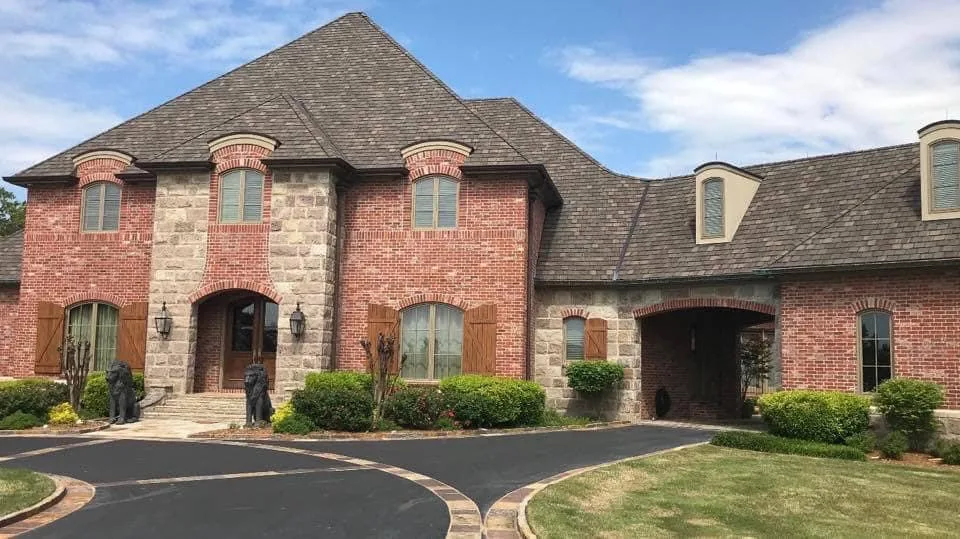 Two-story brick home with a shingle roof from CAR’s residential portfolio